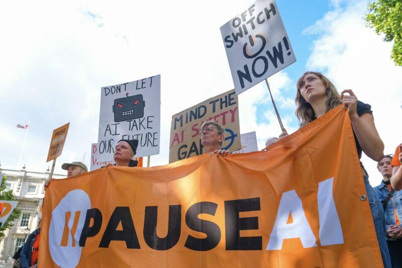 Protesters holding a PauseAI banner and placards outside Downing Street