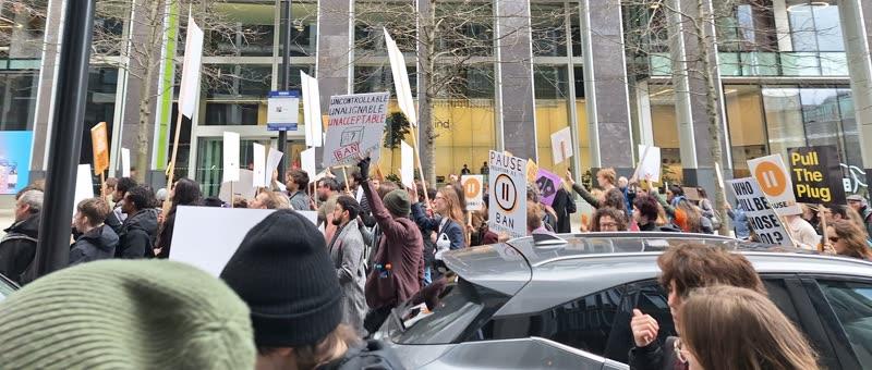 Marchers walking past DeepMind offices
